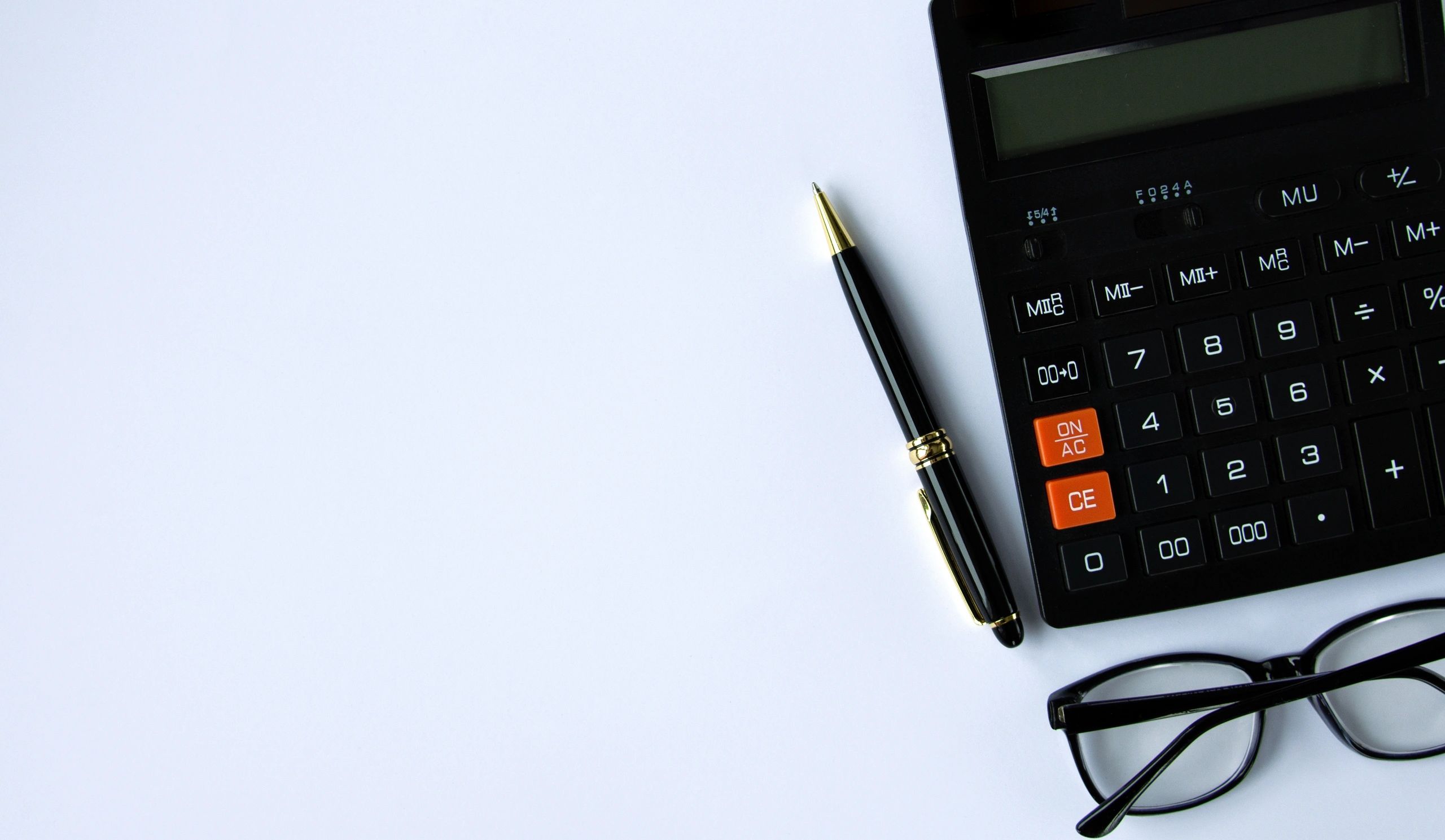 Calculator and notebook representing budgeting and loan planning