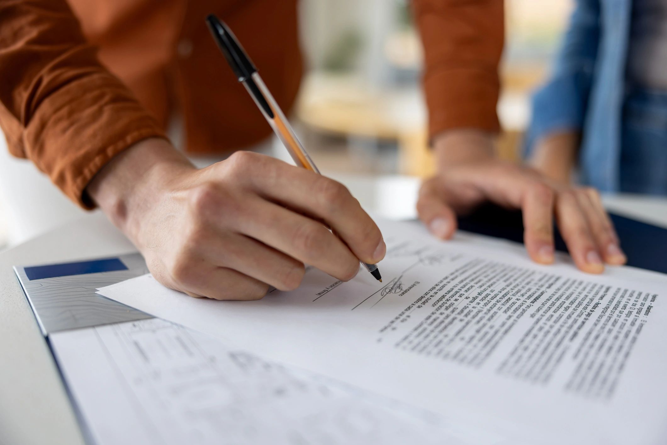 Close-up of signing mortgage paperwork